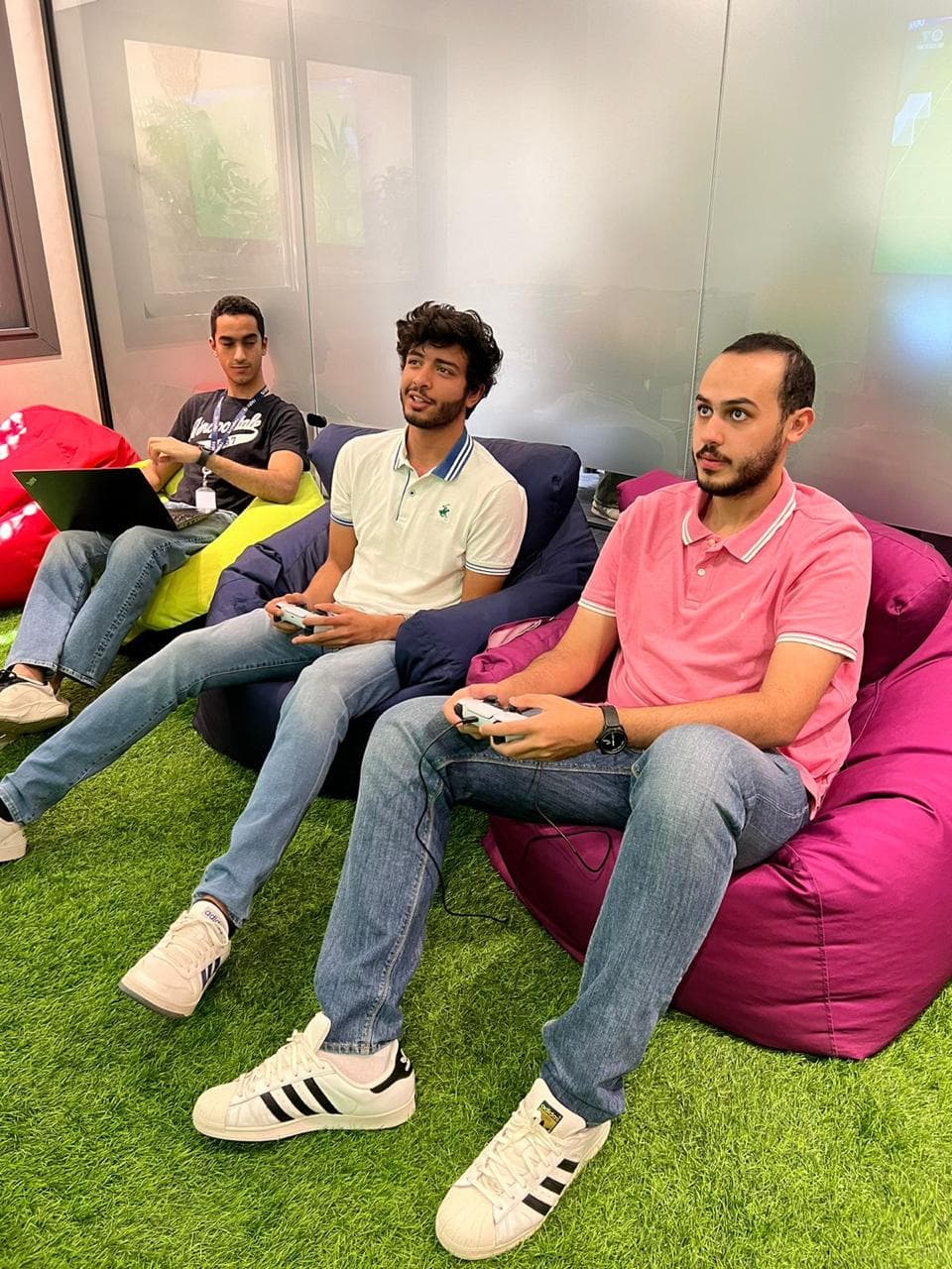 Break room — three consultants on bean bags.