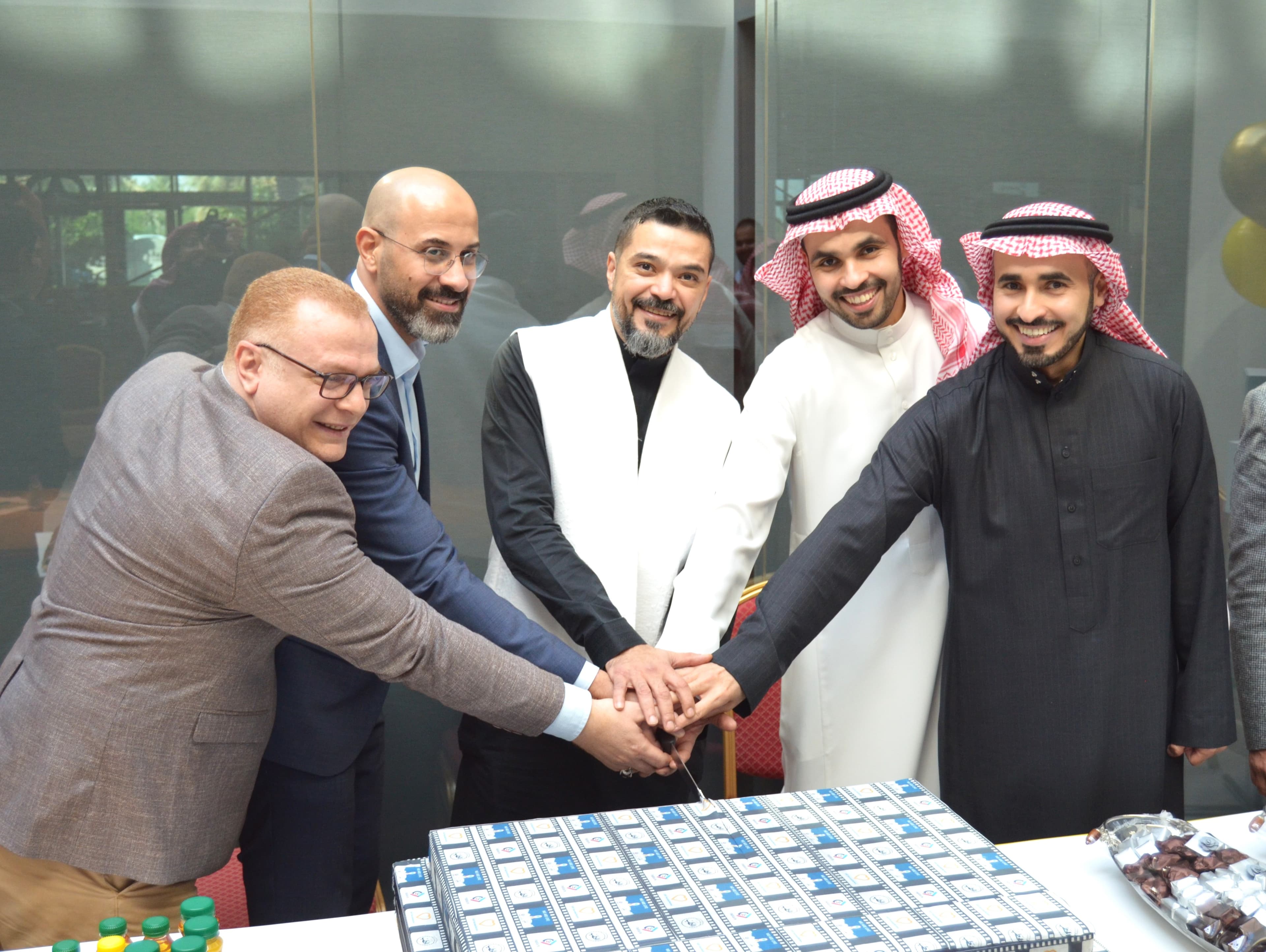 Go-live moment — Raptors and customer leadership cutting a cake together.
