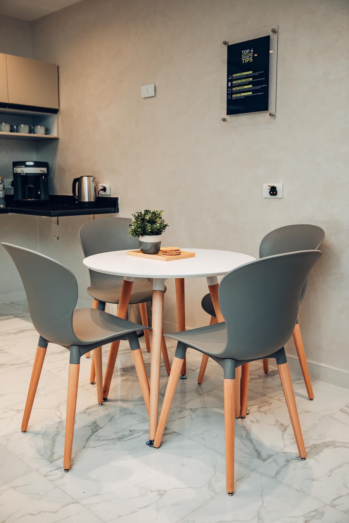 The Cairo office kitchen — table, chairs, plant, morning light.