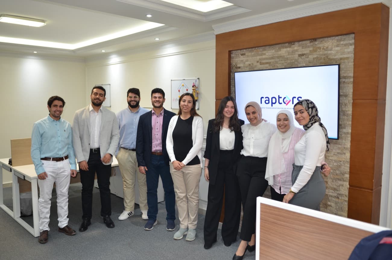 The Raptors team smiling together in the office.