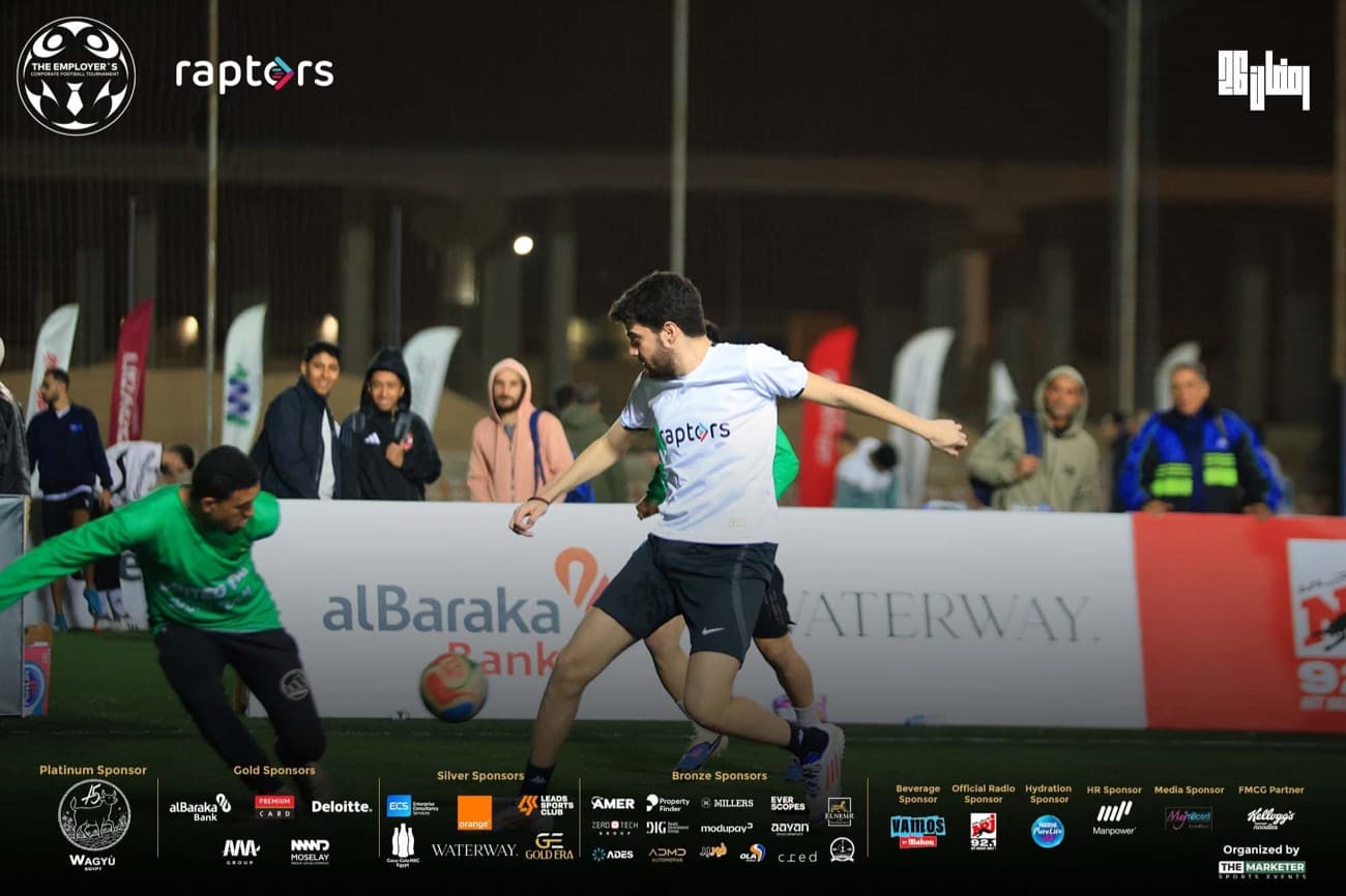 A five-a-side match with the team watching from the touchline.